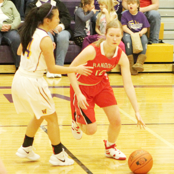 Carlie Nordhues moves the ball closer to the paint during action Friday at Wausa. The Lady Cards earned the L&amp;C Conference win.