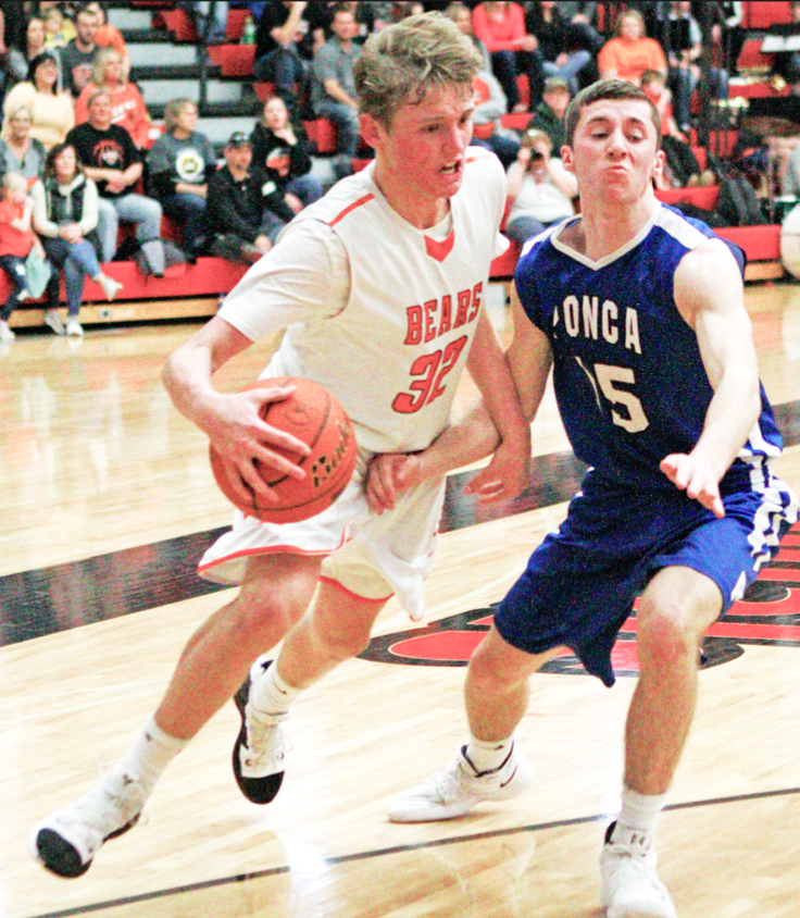 LCC’s Ty Erwin drives past Ponca’s Brandon Kneifl for two points during Monday’s C2-8 District final. The Bears and Indians met for the fourth time this season, with the Indians earning the trip to state with a 55-45 win.