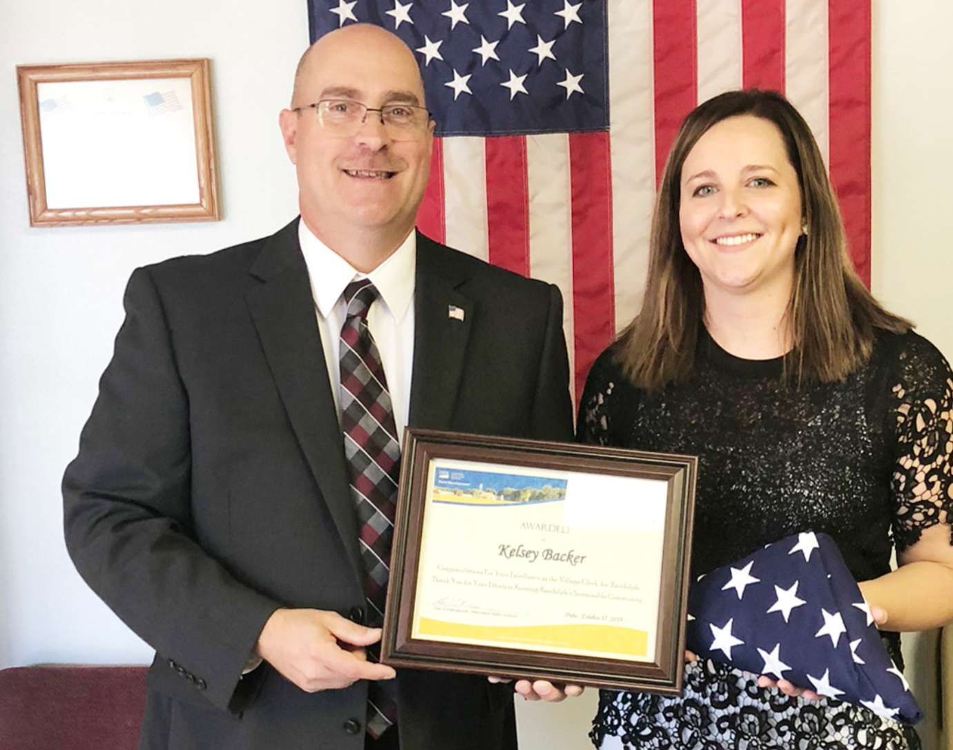 U.S. Dept. of Agriculture Rural Development State Director Karl Elmshaeuser presented Randolph City Clerk Kelsey Backer last week with a plaque as the City Clerk of the Year.