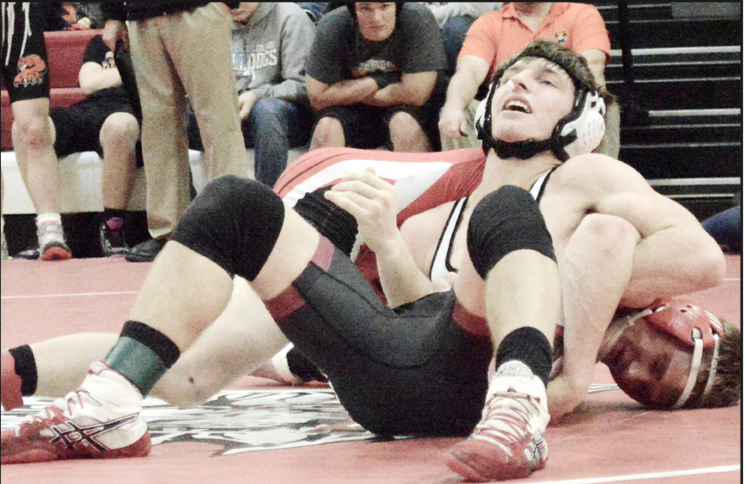 Randolph’s Alex Schmit gets into position to turn Cedar Catho- lic’s Turner Korth onto his back during action in Saturday’s Winside Invitational.