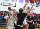Regina Lorenz | Osmond Republican Hunter Buchanan, among a crowd of Hawks and Cardinals, reaches up and snags the ball in game at Osmond last Thursday